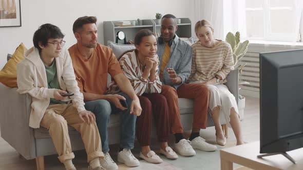 Man Scaring Woman Watching TV