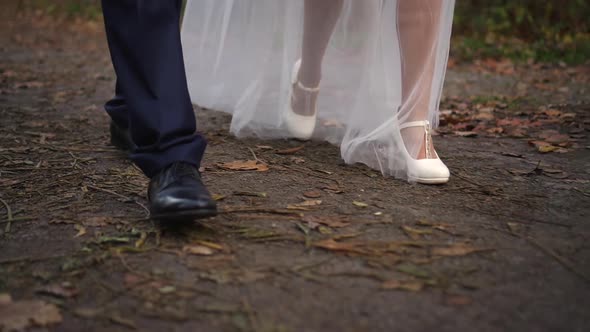 Bride and Groom Walking in the Park