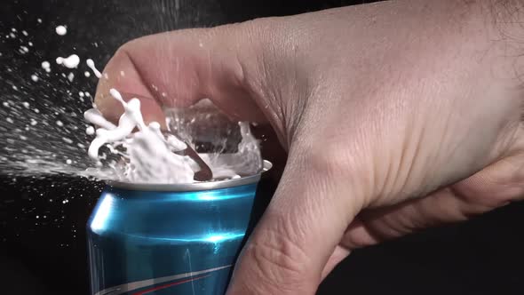 Slow motion of  can opening and spraying as tab is being pulled. alt
