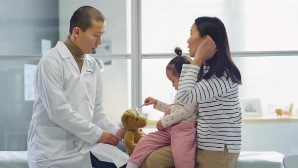 Asian Mother of Toddler Girl Consulting with Pediatrician