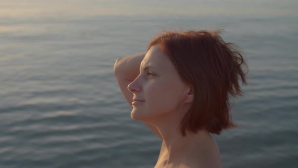 Pensive 30s Woman Standing By the Sea and Enjoy Time Alone