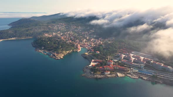 Aerial view above the clouds of Veli Losinj cityscape, Croatia.