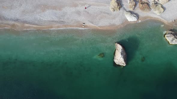 Aerial View From Above on Azure Sea and Pink Pebbles Beach