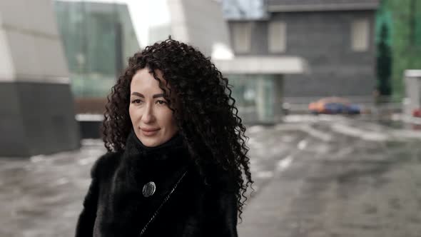 Extravagant Brunette Woman is Walking in City at Winter Day Portrait in Movement Female City Dweller