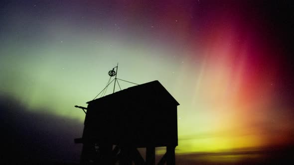 middle latitude aurora (northern lights) at the shipwreck shelter on the island of Terschelling