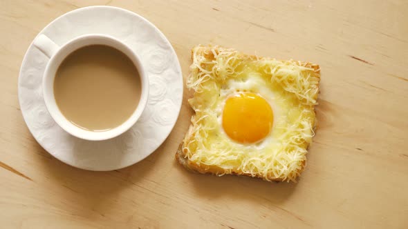 Top View of Toast with Fried Eggs and Coffee on Wooden Kitchen Table