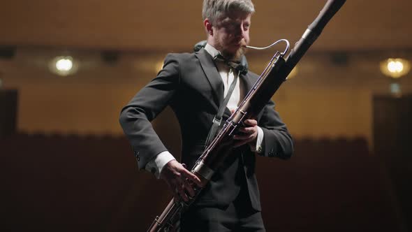 Talented Musician is Playing Bassoon in Scene of Music Hall in Evening Rehearsal of Symphonic