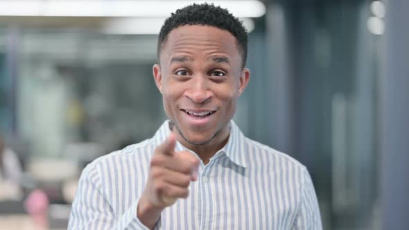African Businessman Pointing at Camera Inviting