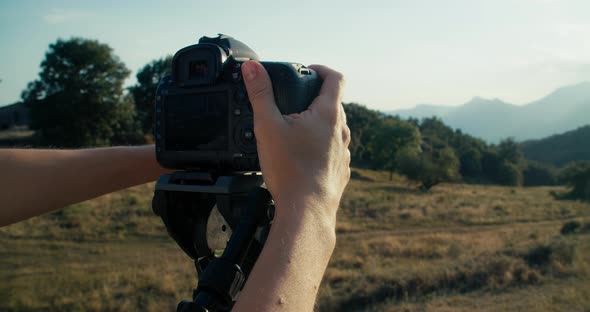 Woman Hands Closeup Adjust Photographic Equipment on Tripod at Mountain Travel