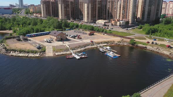 Aerial Drone shot of docked boats at the port of a residential building compound next to the Western