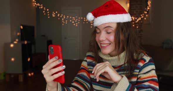 Festive Lady Talks on Video Call Holding Smartphone Closeup