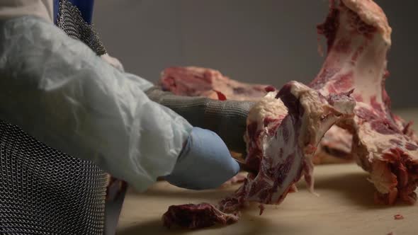 Close Up Shot of Butcher Cuts Fresh Beef Meat Using Sharped Butcher Knife Meat Production and Food