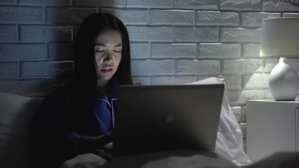 Girl Working on Laptop in Bedtime, Nervous About Bugged Software, Slow Internet