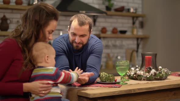 Mother, Father and a Baby Have a Fun in Modern Kitchen