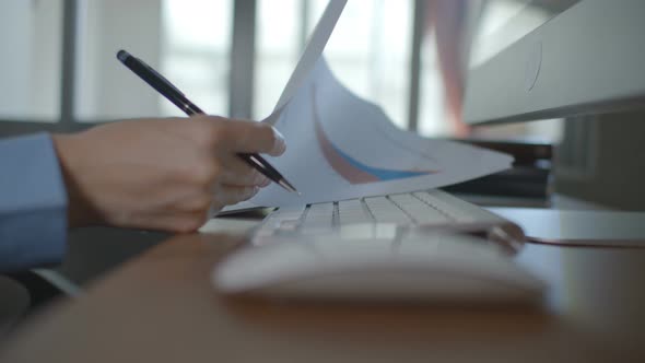 Businesswoman Working With Graph In Office