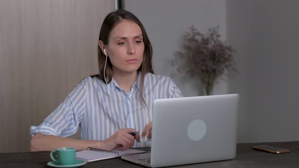 Young Female Student in Headphones Studying at Home Online Education