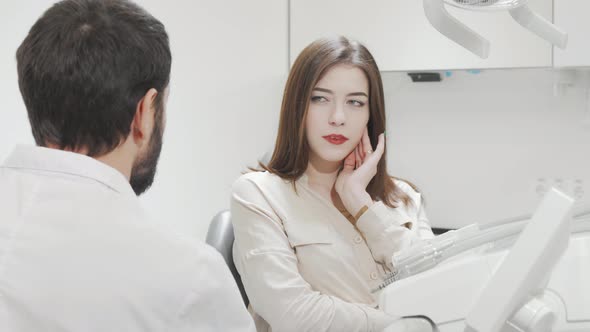 Female Patient with Toothache Visiting Dentist at the Clinic