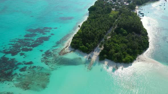 Tropical overhead copy space shot of a white paradise beach and blue water background in 4K