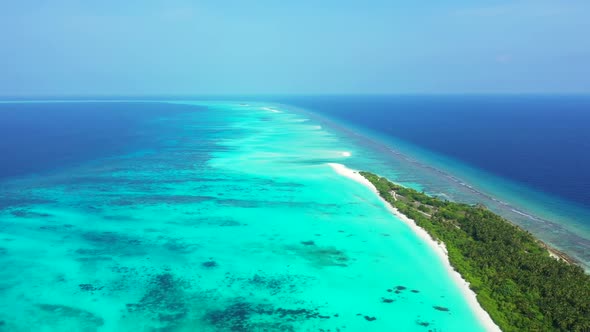 Aerial top down scenery of perfect tourist beach wildlife by blue green lagoon with white sandy back