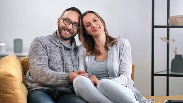 Portrait of Happy Couple Hugging Smiling Relaxing on Comfy Couch