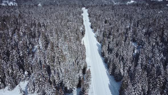 Car is going in the snowy road aerial