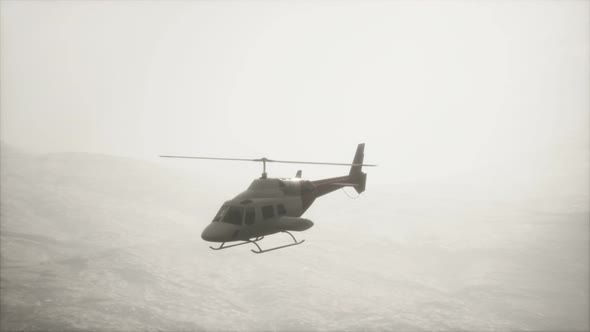 Extreme Slow Motion Flying Helicopter Near Mountains with Fog