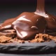 Chocolate pouring on chocolate bars on black slate background - VideoHive Item for Sale