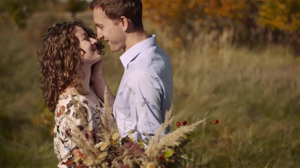 Young Couple in Love Walking on Meadow in Summer - Togetherness Concept.