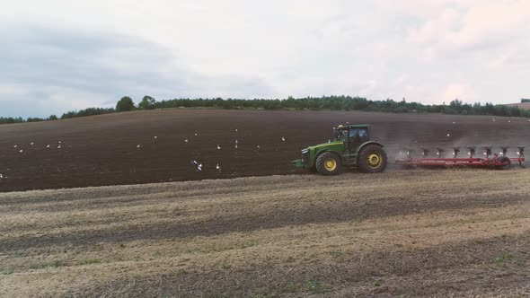 Agricultural Tractor Plows A Big Field