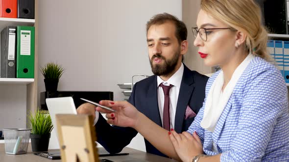 Business Partners Talking in Front of Computer Screen