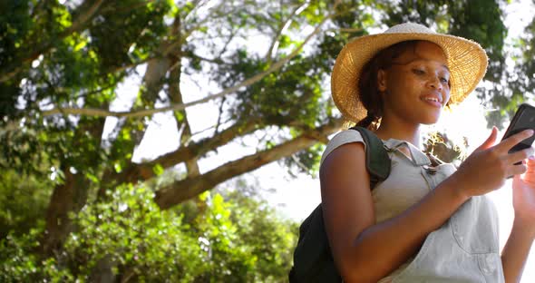 Female hiker using mobile phone at countryside 4k