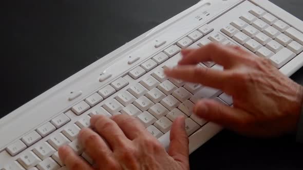 Busy hands typing and working on a computer keyboard . alt