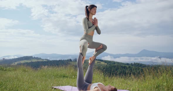 Sporty Women Practising Acrobatic Yoga on Fresh Air