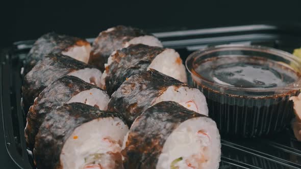 Japanese Sushi Rolls in Plastic Box is Rotating
