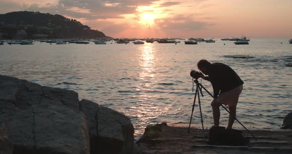 Photographer Creates Content with Camera in Sunset