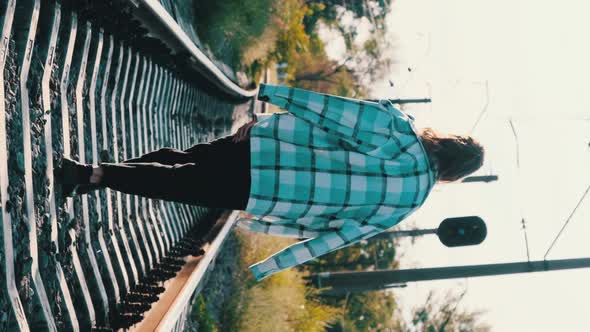 Vertical Video Young Beautiful Woman Walks Alone on the Railway Track