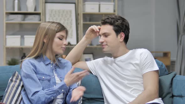 Happy Girl Talking with Boyfriend Relaxing on Couch, Discussing