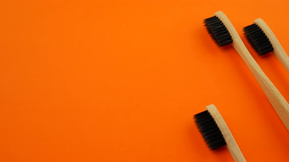 Toothbrushes on Orange Background