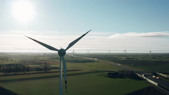 Aerial Drone View Windmills Wind Turbines Producing Clean Ecological Electricity By Road in Green