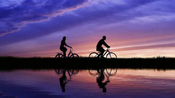 Silhouette Of Cycling On Sunset Background