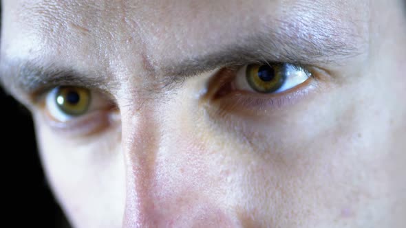 Serious Look of a Young Man Who Concentrated Works on a Black Background. Slow Motion