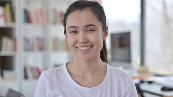 Portrait of Cheerful Young Asian Woman Laughing at Camera 