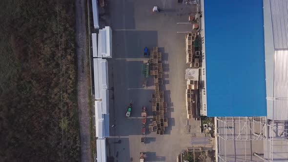 Two Loaders are Transporting Pallets with Apples in the Warehouse 