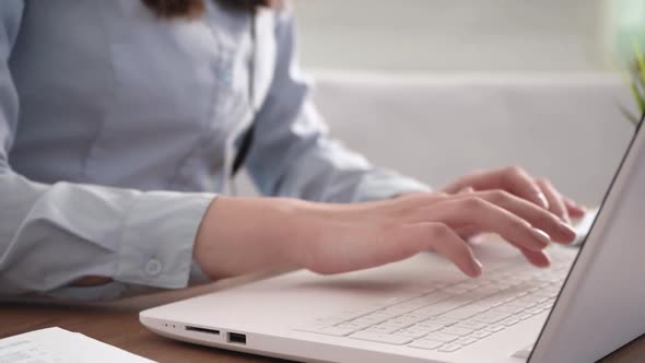 A Woman's Hands are Typing on Her Laptop