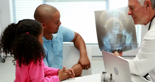 Male doctor discussing x-ray report with patient