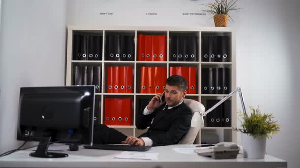 Smiling Happy Businessman Work in Office and Speak with Phone