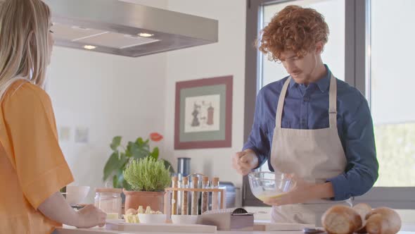 Man Beating Whisking or Mixing Eggs