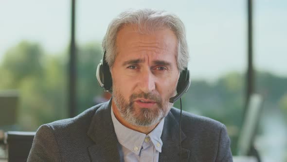 Man with headset speaking and gesturing
