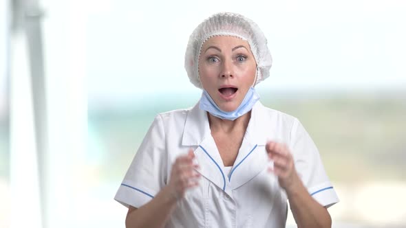 Excited Woman Doctor on Blurred Background