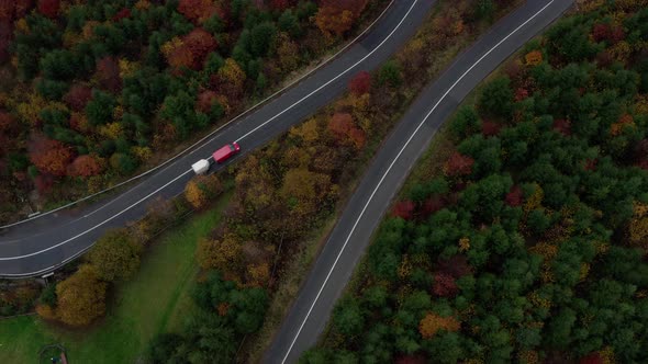 Top-down View Of Cars Driving On Curve Road Through Forest With Autumnal Trees. - aerial